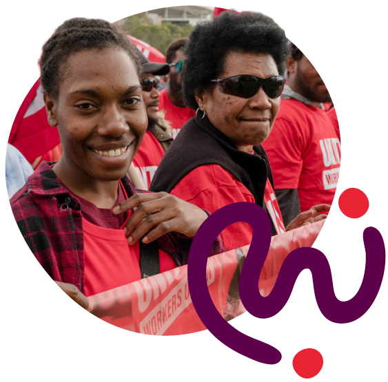 Two women smiling at a rally